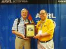 Central Division Director Dick Isely,W9GIG (right), presents Carl Luetzelschwab, K9LA (left), with the award plaque for the 2013 Bill Orr, W6SAI, Technical Writing Award. [Becky Schoenfeld, W1BXY, photo]